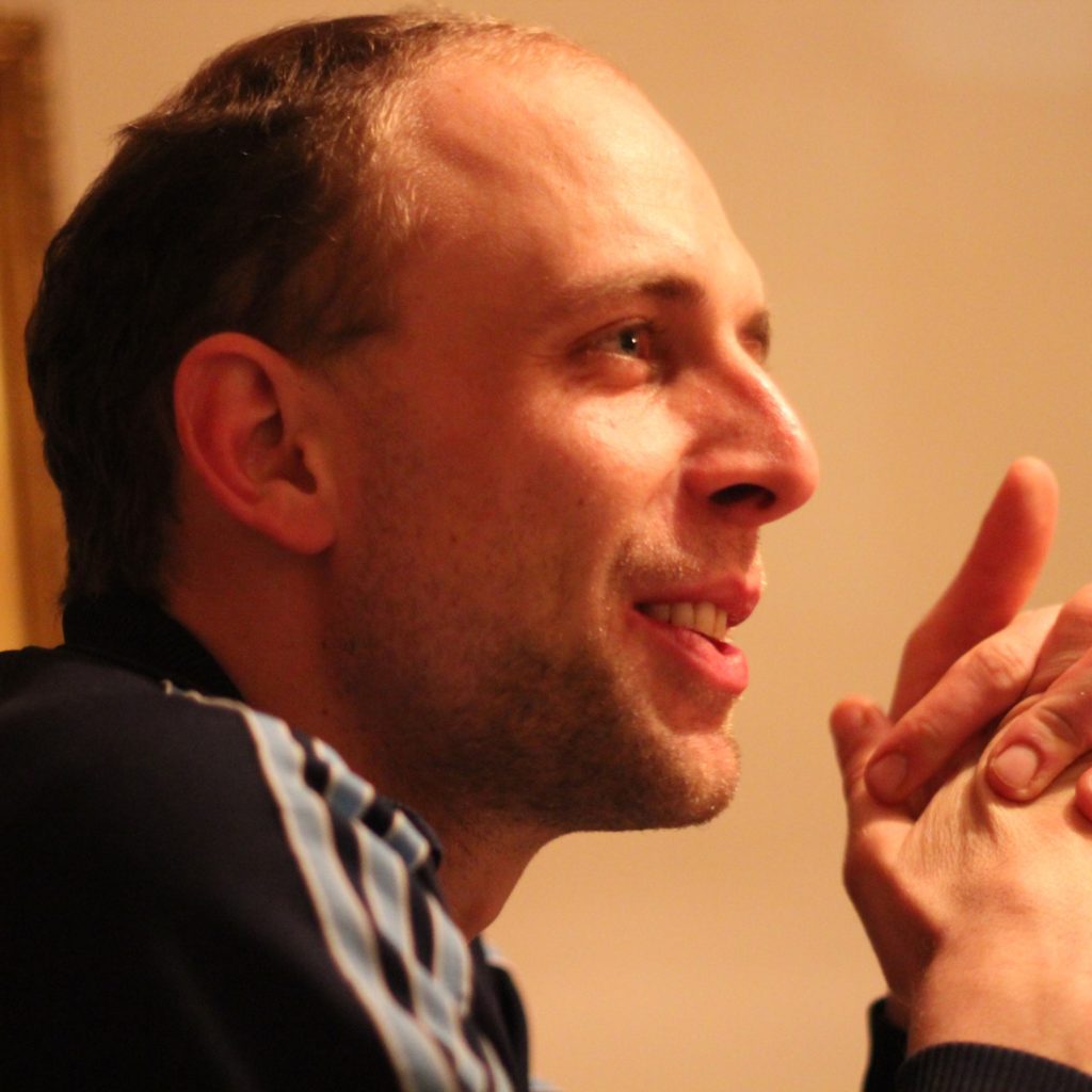 Headshot of Jakob Kapeller in a room staring off into the distance