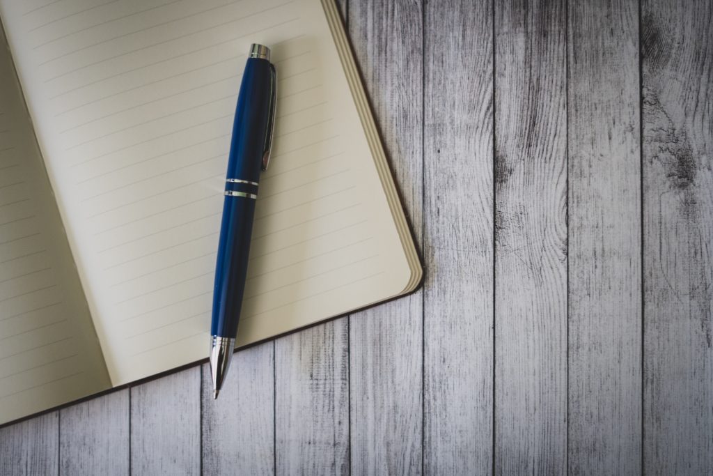 Open notebook with pen resting on top