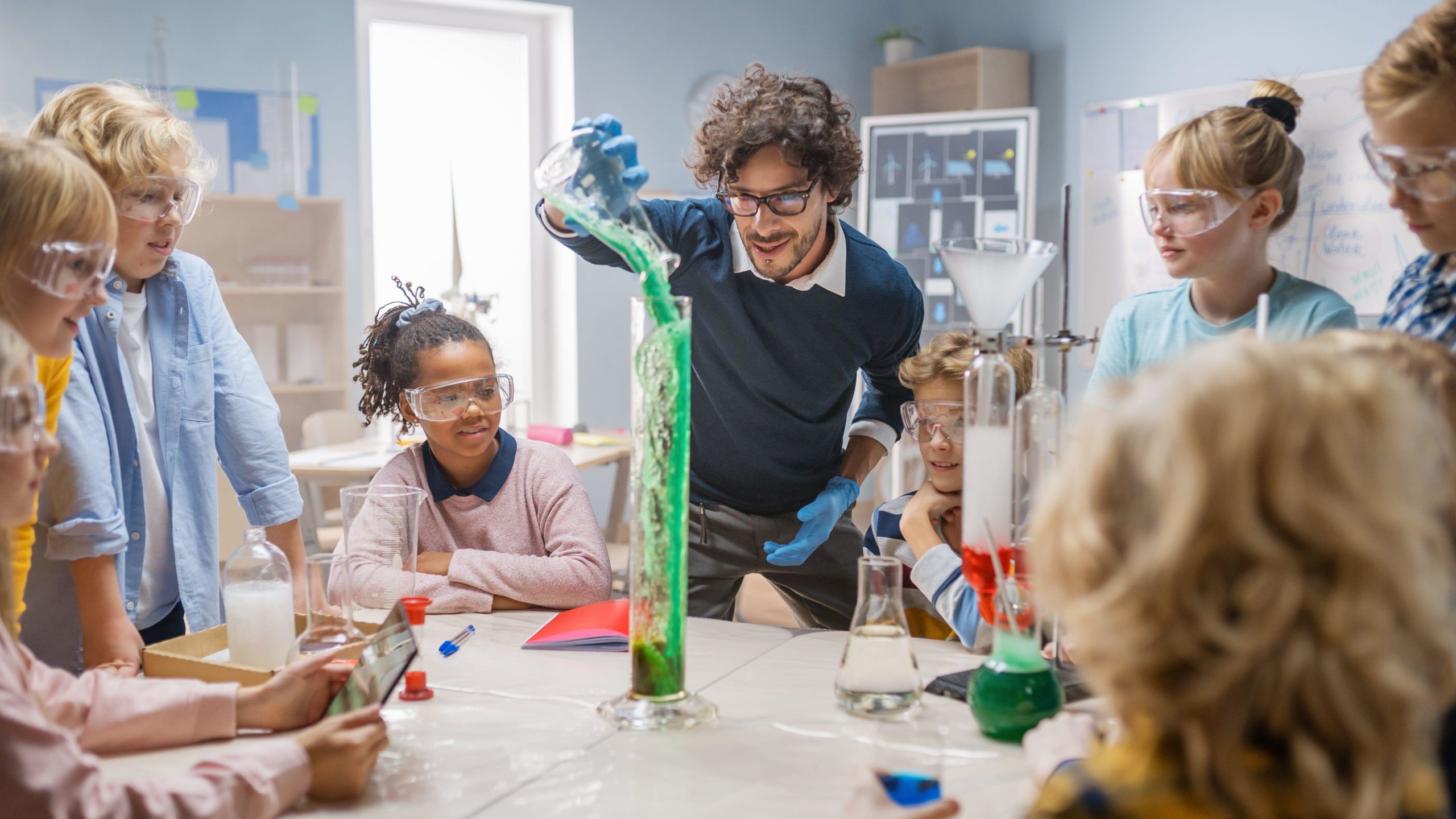Elementary School Science Chemistry Classroom: Teacher Shows Chemical Reaction Experiment to Group of Children