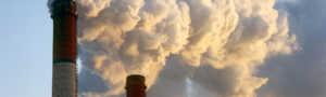 photograph of air pollution, with smoke billowing from industrial chimneys