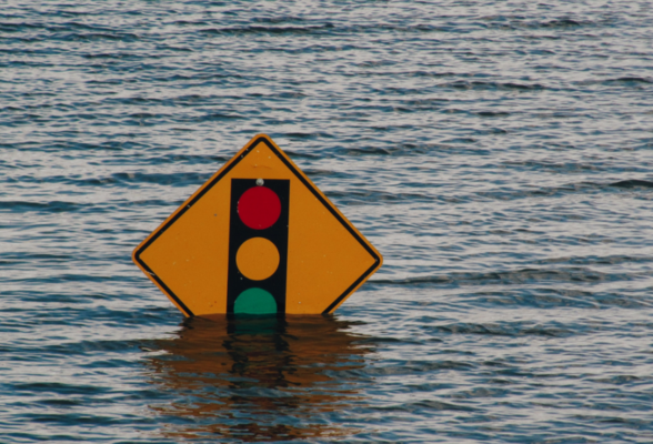 traffic sign submerged halfway in the sea