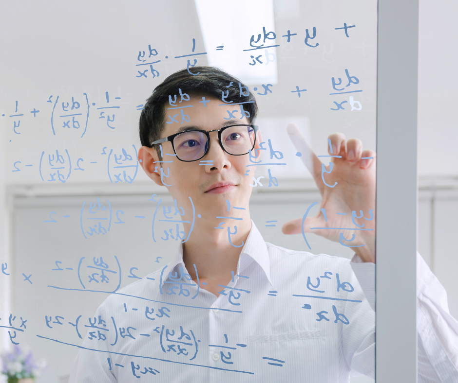 Man with glasses writing math equations on clear plexiglass
