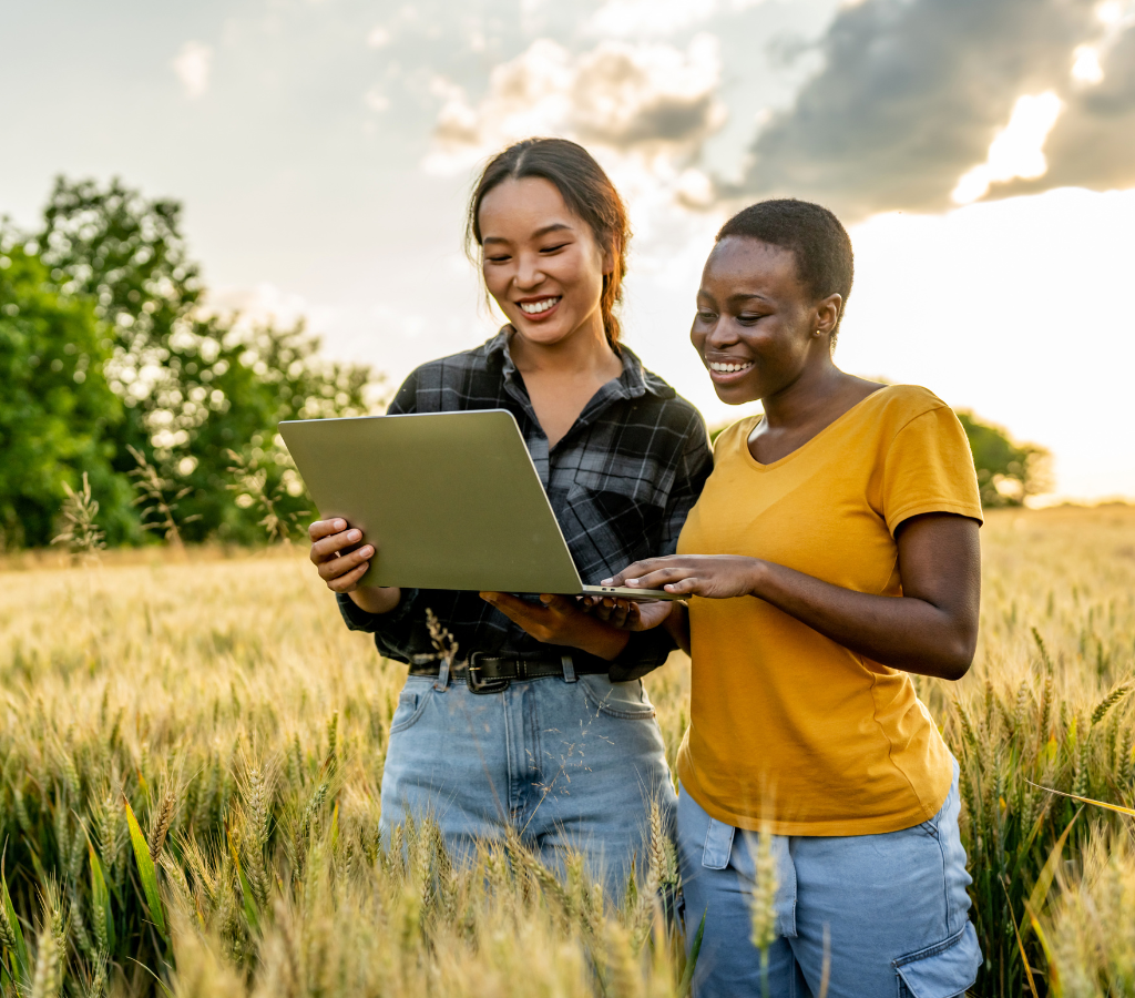 2 women researcher using laptop in a field