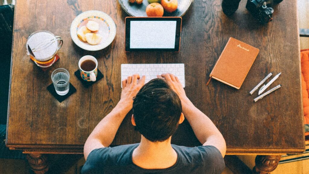 Person typing at a table. 