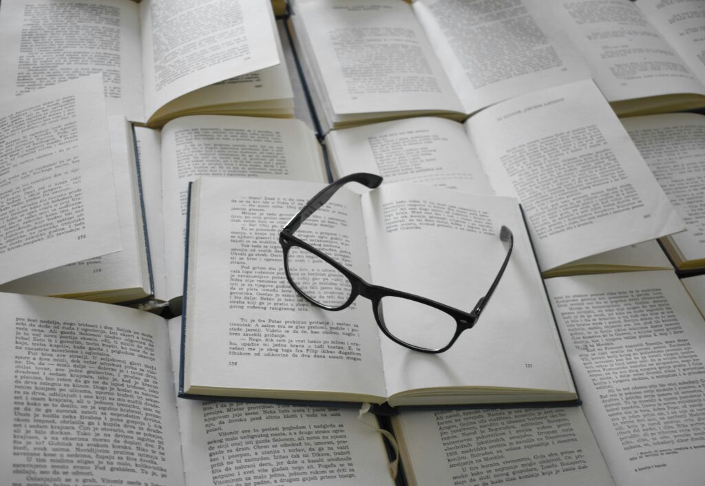 Eye glasses on top of open books. 