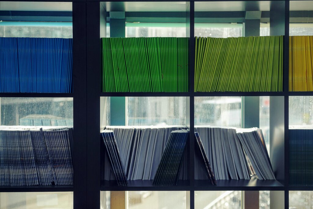 Booklets aligned on shelves. 
