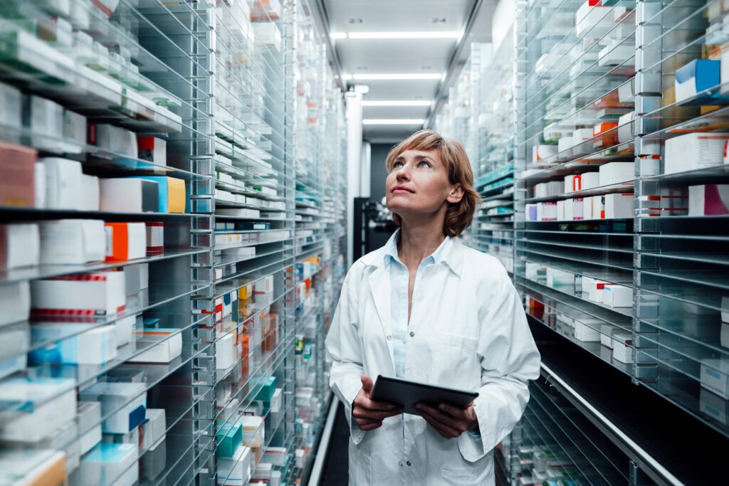 Pharmacist inspects medications.